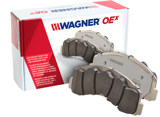 Two Wagner OEX brake pads in front of the box they came in