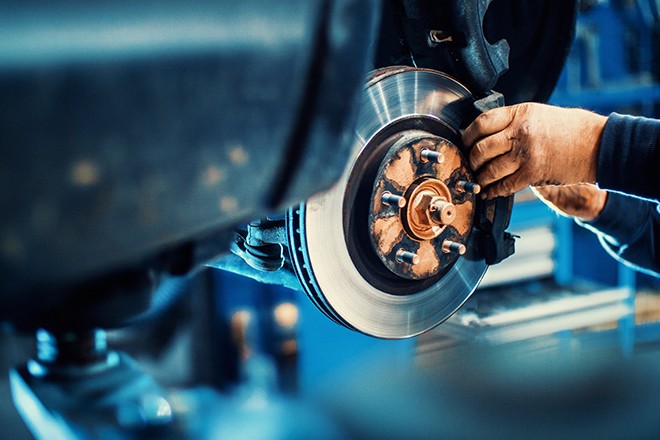 Mechanic-Working-On-Brakes Mechanic-Working-On-Brakes