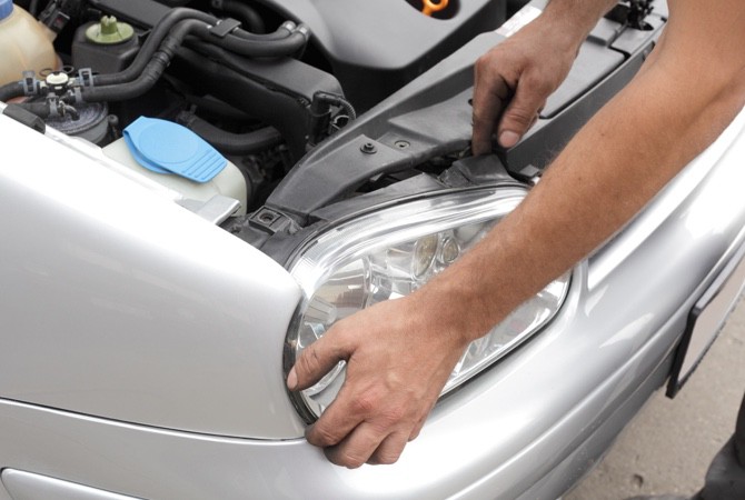 Mechanic-Working-On-Car-Headlight Mechanic-Working-On-Car-Headlight
