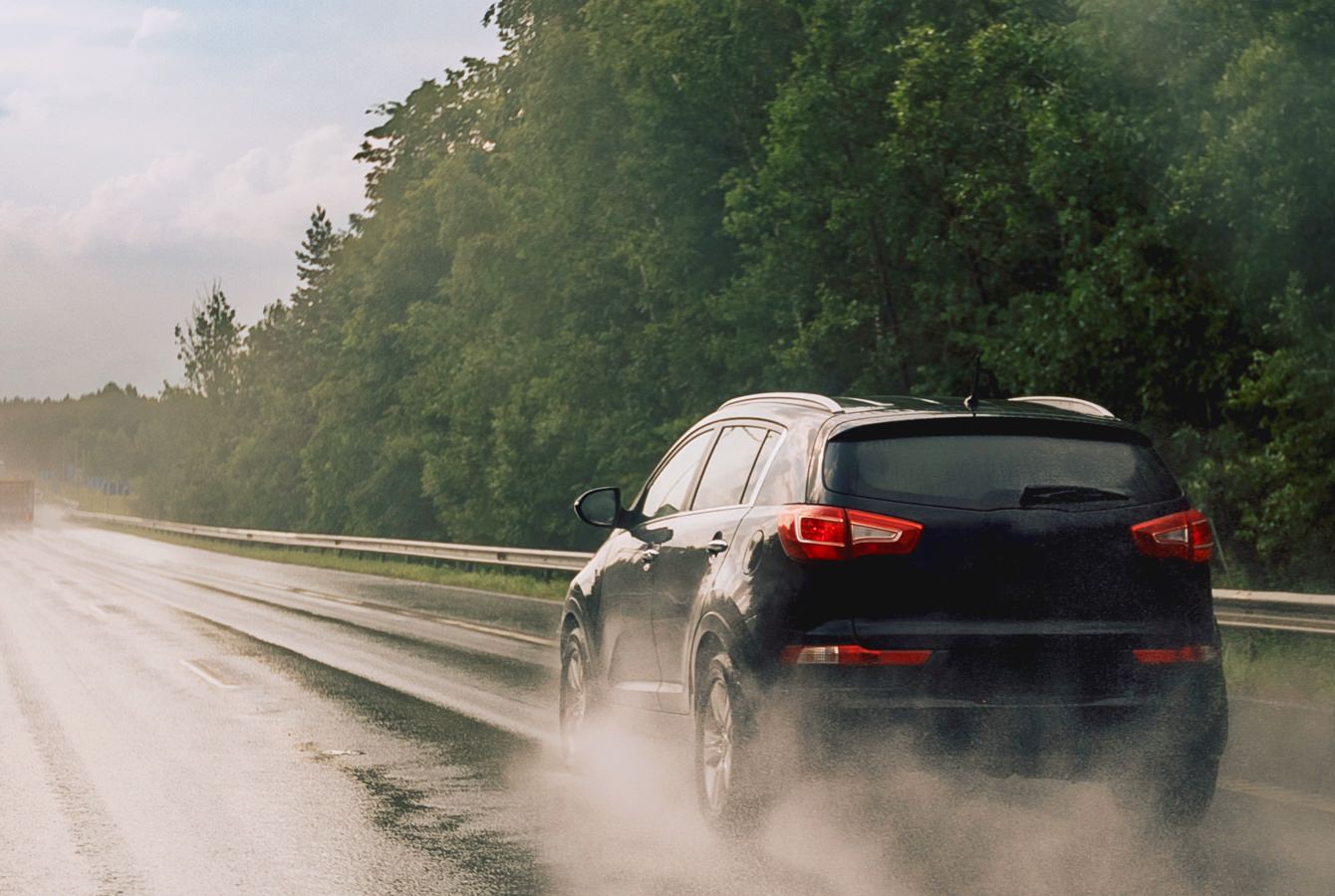 Black Suv Driving On Wet Road Black Suv Driving On Wet Road