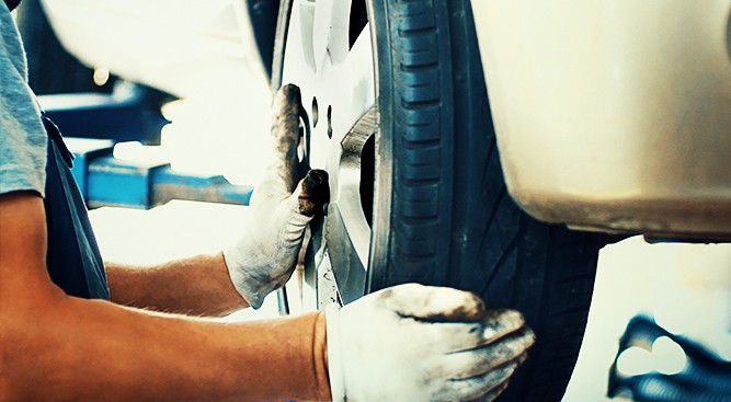 Mechanic-Inspecting-Car-Tire Mechanic-Inspecting-Car-Tire