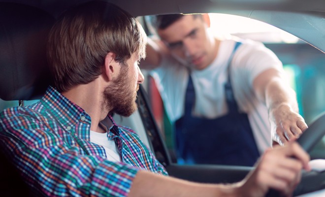 Mechanic-Explaining-To-Customer-In-Their-Vehicle