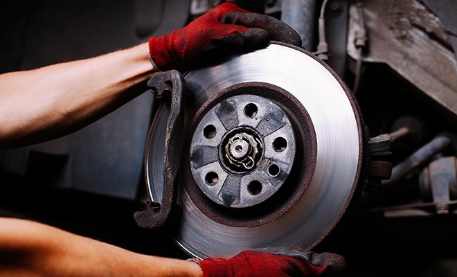 Mechanic-Inspecting-Brake-Close-Up Mechanic-Inspecting-Brake-Close-Up