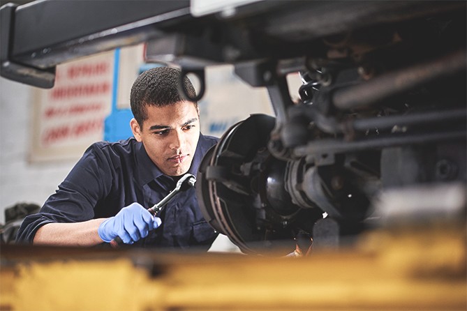 Mechanic-Working-On-Brakes Mechanic-Working-On-Brakes